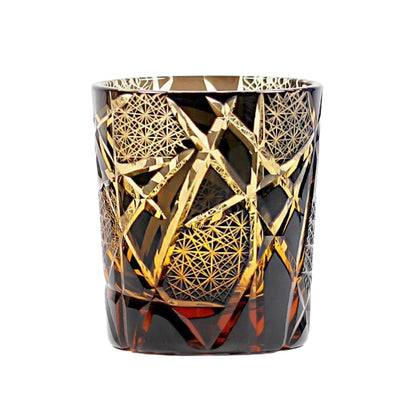 Handmade Edo Kiriko whiskey glass in amber with intricate gold lattice design
