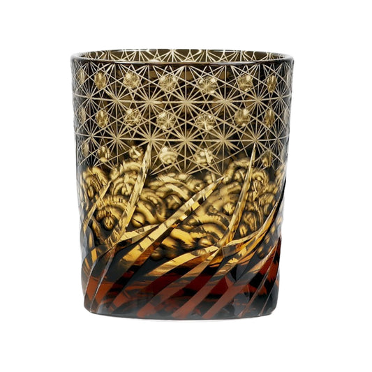 Edo Kiriko whiskey glass with golden geometric pattern over black and amber gradient base