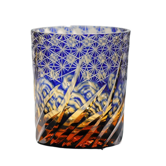 Edo Kiriko whiskey glass with blue and amber gradient, intricate star and wave engravings