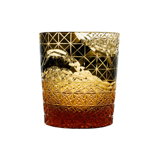 Black Edo Kiriko whiskey glass with golden traditional Japanese pattern and amber gradient base.