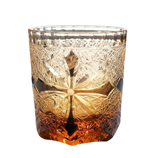 Edo Kiriko whiskey glass – amber base with intricate black crosscut and traditional Japanese star motif.


