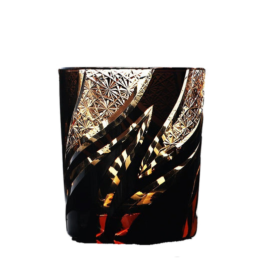 Homura Edo Kiriko whiskey glass – black base with gold pattern and deep red highlights.


