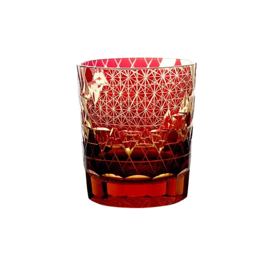 Red Edo Kiriko whiskey glass with intricate gold cut pattern on transparent base
